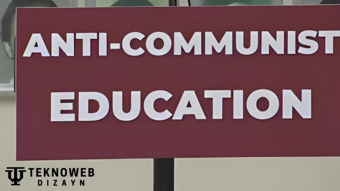 A maroon sign with bold white letters displaying the words "Anti-Communist Education," symbolizing a focus on promoting anti-communist perspectives in educational settings.