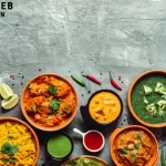 Congolese Cuisine Food spread with colorful dishes, including stews, curries, rice, naan, and sauces, garnished with herbs and spices on a rustic gray background.