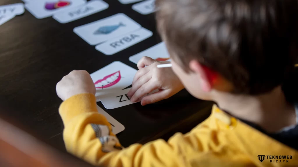 A preschool child interacting with educational cards, promoting learning through hands-on activities and advanced preschool programs.