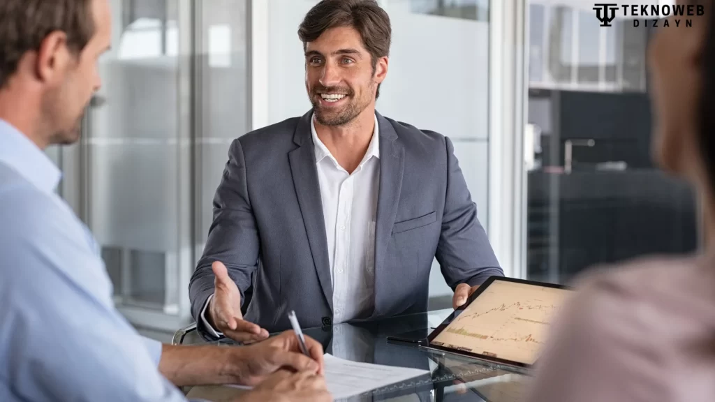 A business consultant presenting data on a tablet while engaging in a meeting at a modern office table.